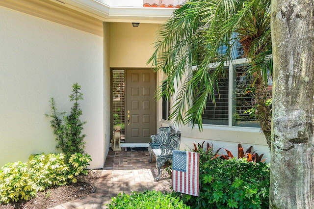 112 Palm Bay Dr Unit A, Palm Beach Gardens, FL 33418 - doorway to property featuring stucco siding