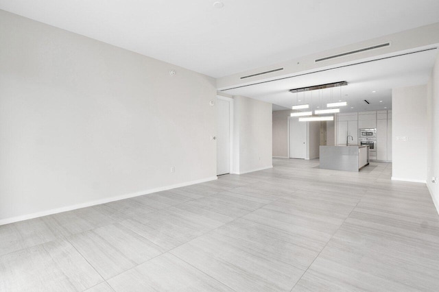 200 SE Mizner Blvd Unit 514, Boca Raton, FL 33432 - unfurnished living room featuring baseboards and light tile patterned floors