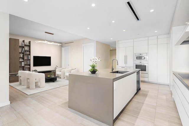 200 SE Mizner Blvd Unit 514, Boca Raton, FL 33432 - kitchen featuring modern cabinets, white cabinets, black electric stovetop, a center island with sink, and recessed lighting