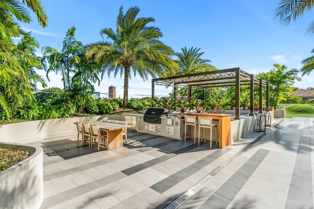 200 SE Mizner Blvd Unit 514, Boca Raton, FL 33432 - view of patio / terrace with a pergola and an outdoor kitchen