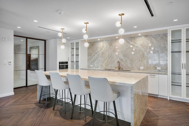 200 SE Mizner Blvd Unit 514, Boca Raton, FL 33432 - kitchen featuring white cabinetry, a center island, decorative light fixtures, glass insert cabinets, and recessed lighting