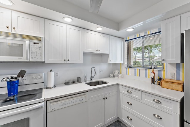 3186 Via Poinciana Unit 111, Lake Worth, FL 33467 - kitchen featuring white appliances, white cabinetry, light countertops, and recessed lighting