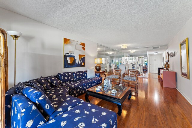 3186 Via Poinciana Unit 111, Lake Worth, FL 33467 - living area with wood finished floors and a textured ceiling