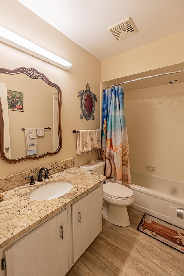 309 NE Jonquil St, Port Saint Lucie, FL 34983 - full bath featuring vanity, wood finished floors, and shower / bath combo