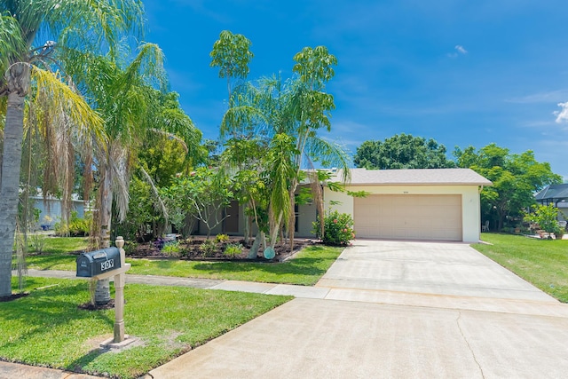 309 NE Jonquil St, Port Saint Lucie, FL 34983 - obstructed view of property featuring driveway, a garage, a front yard, and stucco siding