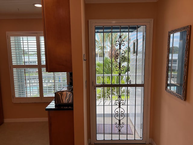 1868 SW Palm City Rd Unit 304, Stuart, FL 34994 - doorway with crown molding and tile patterned floors