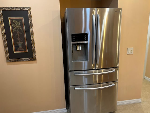 1868 SW Palm City Rd Unit 304, Stuart, FL 34994 - kitchen view of stainless steel refrigerator with ice dispenser and baseboards