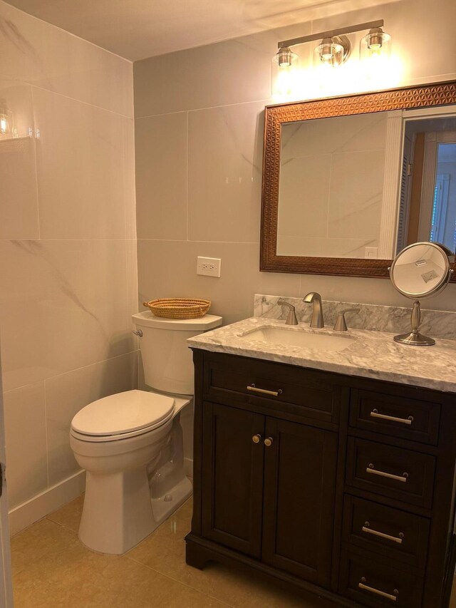 1868 SW Palm City Rd Unit 304, Stuart, FL 34994 - bathroom with tile walls, vanity, and tile patterned floors