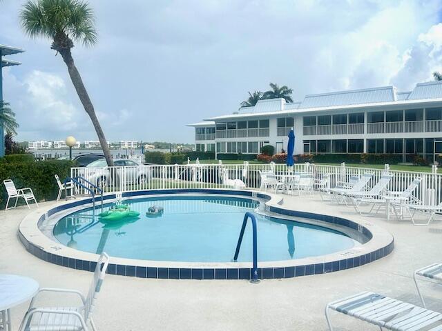 1868 SW Palm City Rd Unit 304, Stuart, FL 34994 - community pool featuring a patio