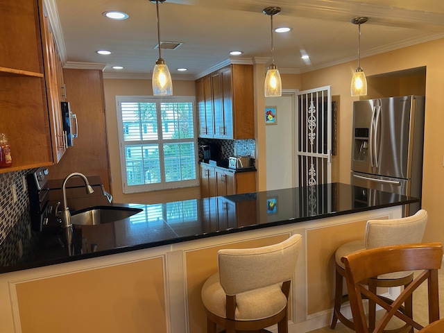 1868 SW Palm City Rd Unit 304, Stuart, FL 34994 - kitchen featuring stainless steel fridge with ice dispenser, brown cabinets, backsplash, dark countertops, and recessed lighting