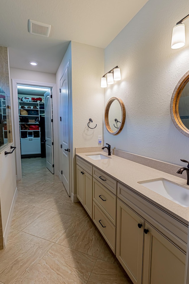 12736 SW Cattleya Ln, Port Saint Lucie, FL 34987 - full bath with double vanity, a walk in closet, and marble look tiles