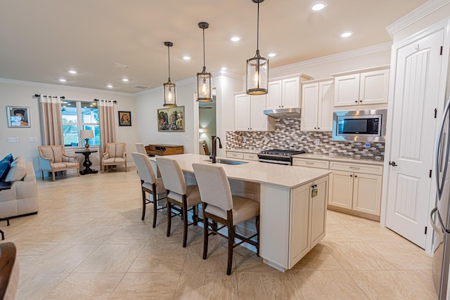 12736 SW Cattleya Ln, Port Saint Lucie, FL 34987 - kitchen with appliances with stainless steel finishes, open floor plan, ornamental molding, a kitchen bar, and tasteful backsplash
