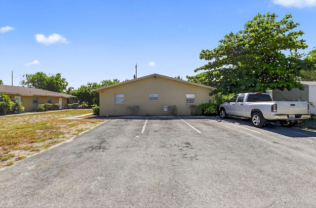 7891 Loomis St Unit 7891/7893, Lake Worth, FL 33462 - view of front facade featuring uncovered parking and stucco siding