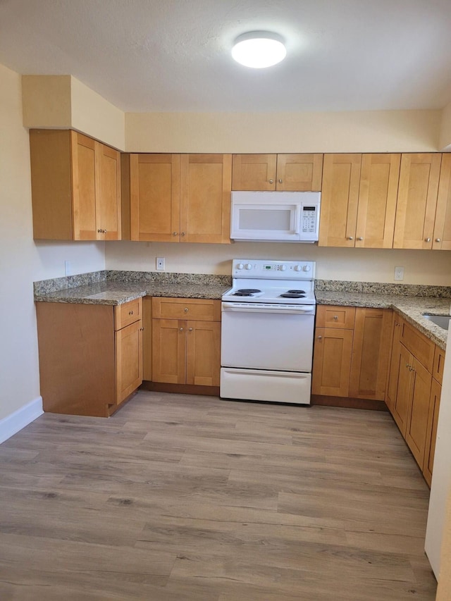 7891 Loomis St Unit 7891/7893, Lake Worth, FL 33462 - kitchen featuring white appliances, light wood finished floors, and stone counters