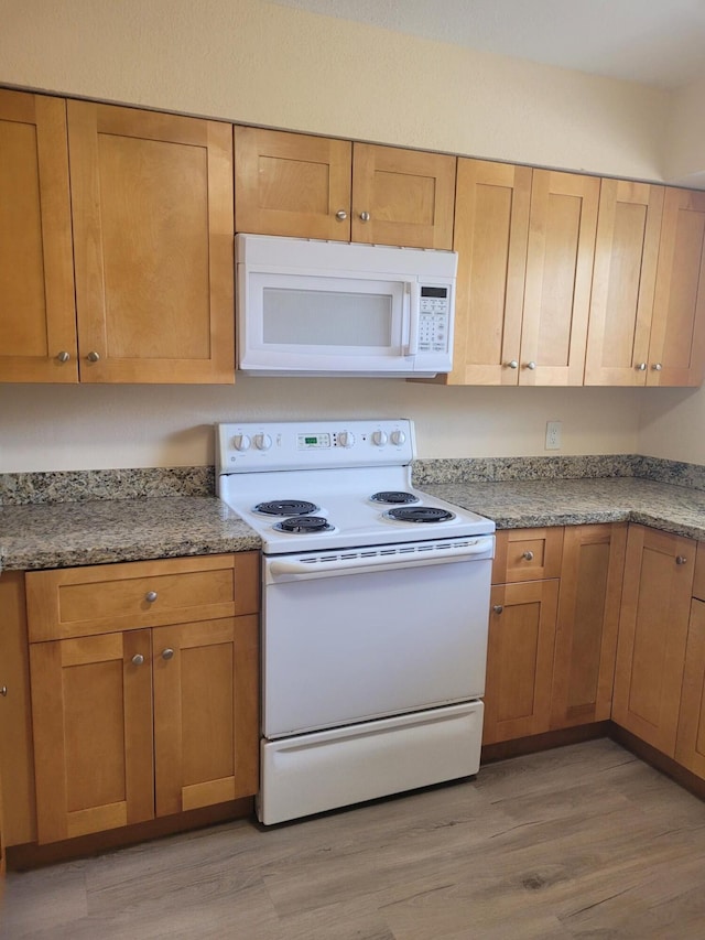 7891 Loomis St Unit 7891/7893, Lake Worth, FL 33462 - kitchen with white appliances and light wood-style flooring