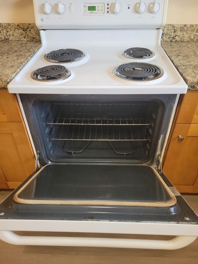 7891 Loomis St Unit 7891/7893, Lake Worth, FL 33462 - kitchen view of white electric range oven and brown cabinetry