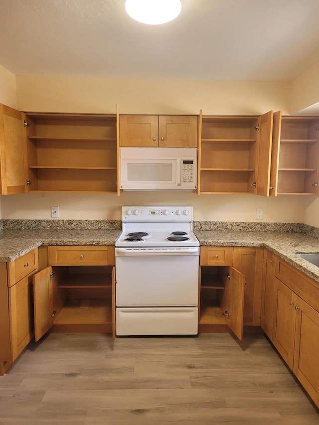 7891 Loomis St Unit 7891/7893, Lake Worth, FL 33462 - kitchen with open shelves, white appliances, light wood-style flooring, and light stone counters