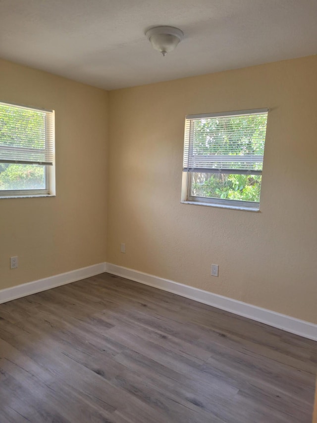 7891 Loomis St Unit 7891/7893, Lake Worth, FL 33462 - empty room with dark wood finished floors and baseboards