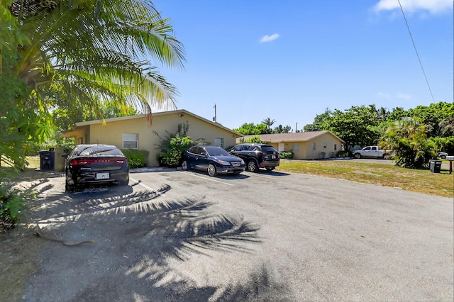 7891 Loomis St Unit 7891/7893, Lake Worth, FL 33462 - view of front of home featuring uncovered parking and stucco siding