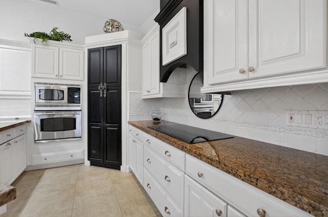 574 Emerald Way E, Deerfield Beach, FL 33442 - kitchen featuring stainless steel appliances, white cabinetry, and decorative backsplash