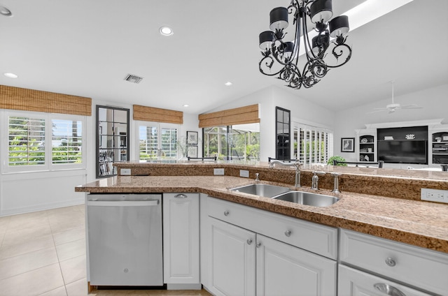 574 Emerald Way E, Deerfield Beach, FL 33442 - kitchen with stainless steel dishwasher, lofted ceiling, plenty of natural light, white cabinetry, and open floor plan