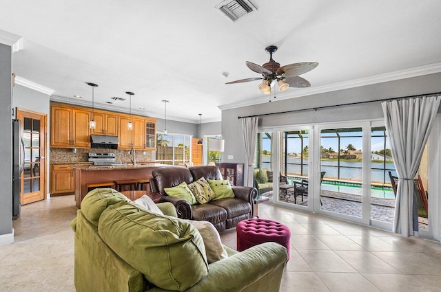 7141 Charleston Point Dr, Lake Worth, FL 33467 - living area featuring ornamental molding, ceiling fan, a water view, and light tile patterned floors