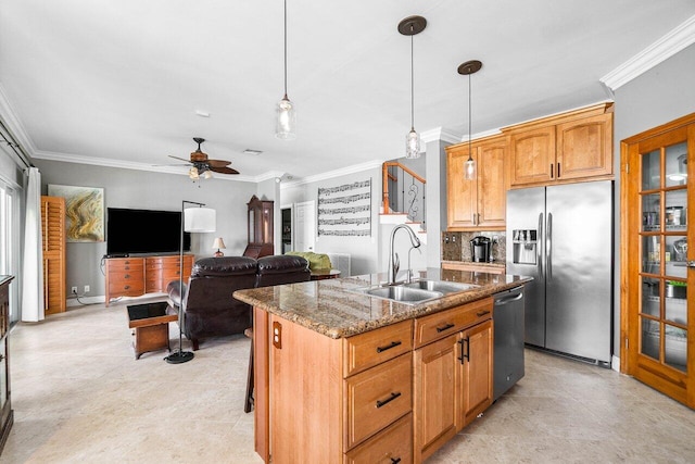 7141 Charleston Point Dr, Lake Worth, FL 33467 - kitchen featuring stainless steel appliances, ornamental molding, a ceiling fan, an island with sink, and stone countertops