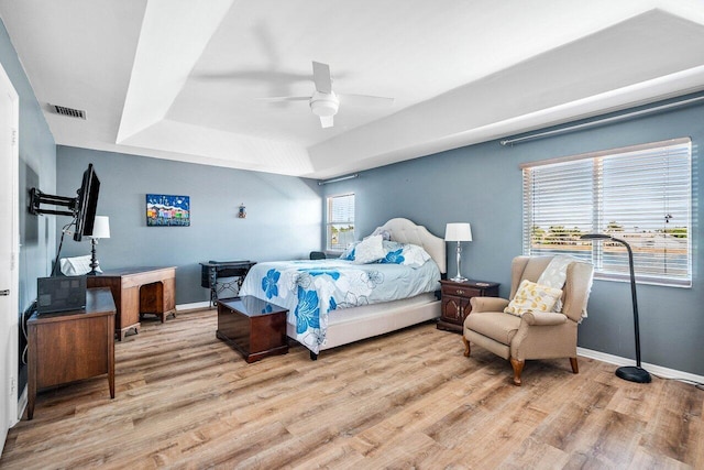 7141 Charleston Point Dr, Lake Worth, FL 33467 - bedroom with light wood-style flooring, a tray ceiling, and ceiling fan