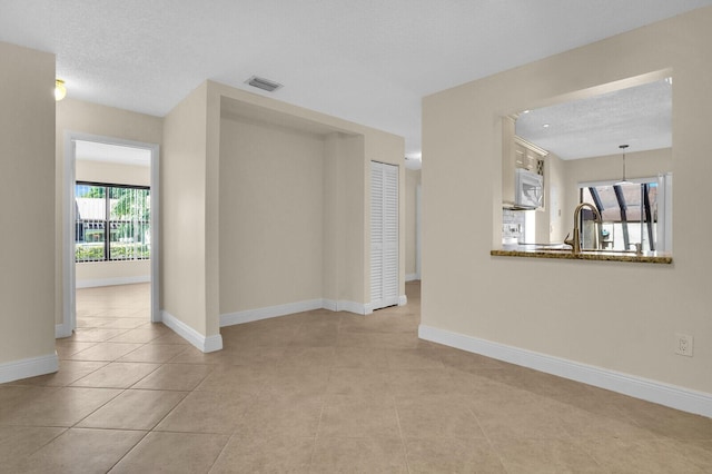 3741 English D Ln Unit D, Lake Worth, FL 33467 - tiled spare room with baseboards and a textured ceiling