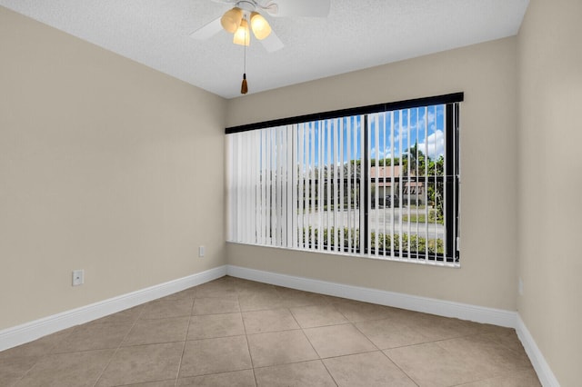 3741 English D Ln Unit D, Lake Worth, FL 33467 - empty room featuring light tile patterned floors, healthy amount of natural light, and a textured ceiling