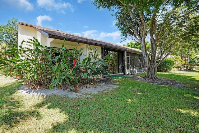 3741 English D Ln Unit D, Lake Worth, FL 33467 - rear view of property with a lawn and a sunroom