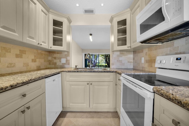 3741 English D Ln Unit D, Lake Worth, FL 33467 - kitchen with white appliances, light stone countertops, and glass insert cabinets