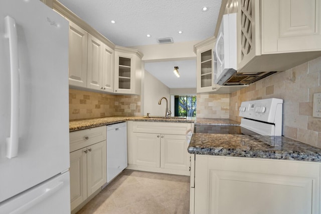 3741 English D Ln Unit D, Lake Worth, FL 33467 - kitchen featuring white appliances, tasteful backsplash, dark stone counters, glass insert cabinets, and light tile patterned flooring
