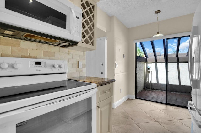3741 English D Ln Unit D, Lake Worth, FL 33467 - kitchen featuring white appliances, decorative backsplash, decorative light fixtures, light tile patterned floors, and a textured ceiling