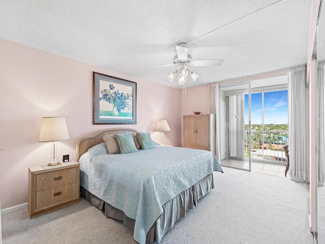 3310 S Ocean Blvd Unit 928D, Highland Beach, FL 33487 - bedroom featuring light carpet, access to outside, a textured ceiling, and a ceiling fan