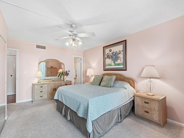 3310 S Ocean Blvd Unit 928D, Highland Beach, FL 33487 - bedroom with light carpet, a ceiling fan, and a textured ceiling