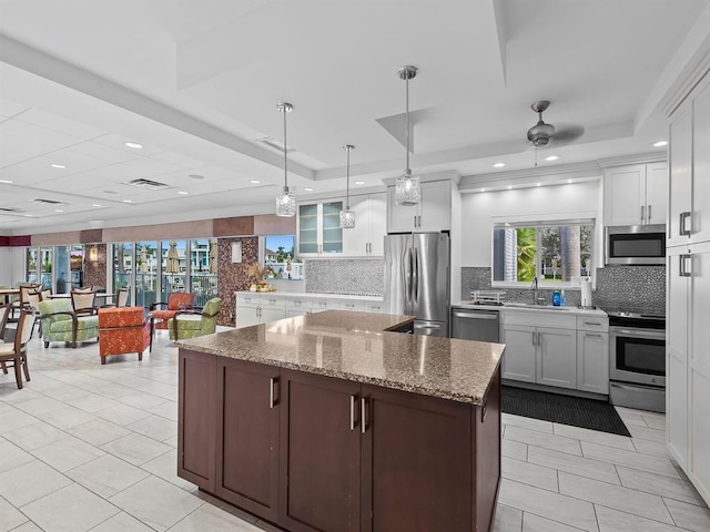 3310 S Ocean Blvd Unit 928D, Highland Beach, FL 33487 - kitchen featuring stainless steel appliances, backsplash, a center island, white cabinets, and recessed lighting