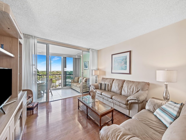3310 S Ocean Blvd Unit 928D, Highland Beach, FL 33487 - living area with a textured ceiling, wood finished floors, and a wall of windows