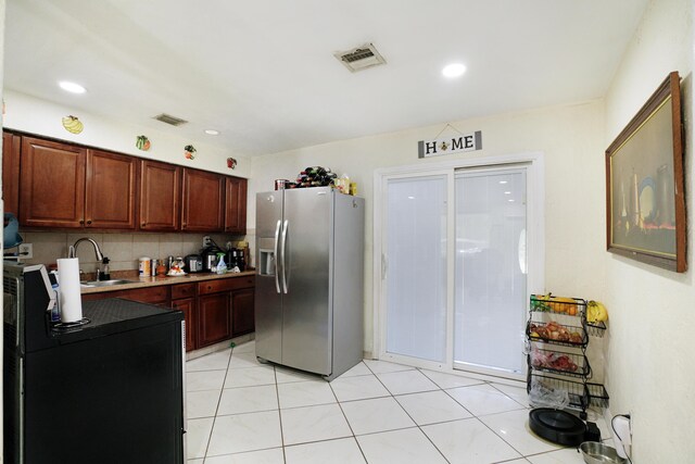 1395 SW 46 Th Ave, Fort Lauderdale, FL 33317 - kitchen with stainless steel refrigerator with ice dispenser, tasteful backsplash, light countertops, light tile patterned floors, and recessed lighting
