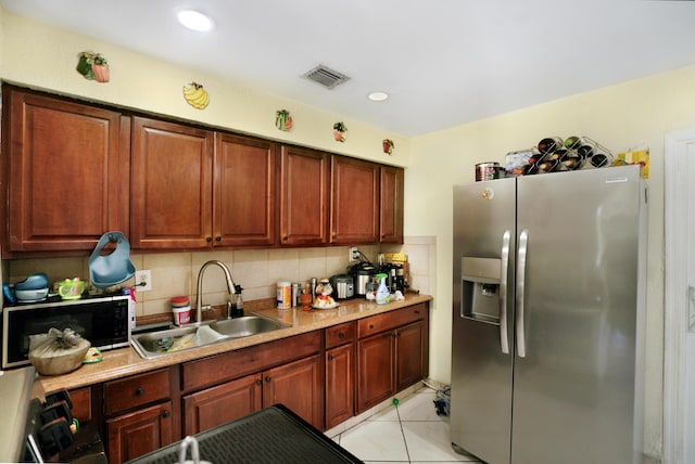 1395 SW 46 Th Ave, Fort Lauderdale, FL 33317 - kitchen with stainless steel refrigerator with ice dispenser, black microwave, backsplash, light countertops, and recessed lighting
