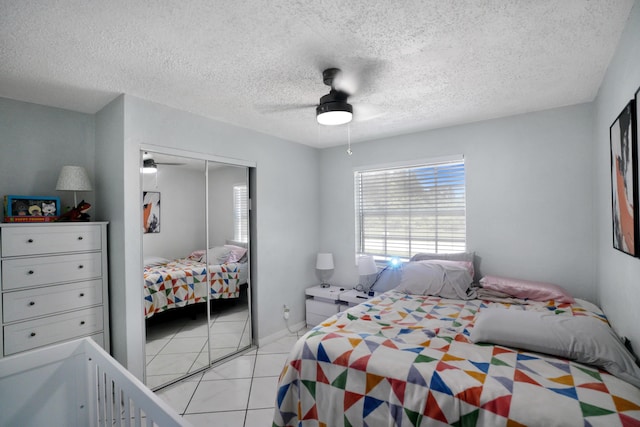 1395 SW 46 Th Ave, Fort Lauderdale, FL 33317 - bedroom featuring a closet, light tile patterned floors, a textured ceiling, and ceiling fan