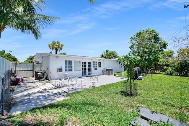 1395 SW 46 Th Ave, Fort Lauderdale, FL 33317 - rear view of property with french doors, stucco siding, a patio area, and a fenced backyard
