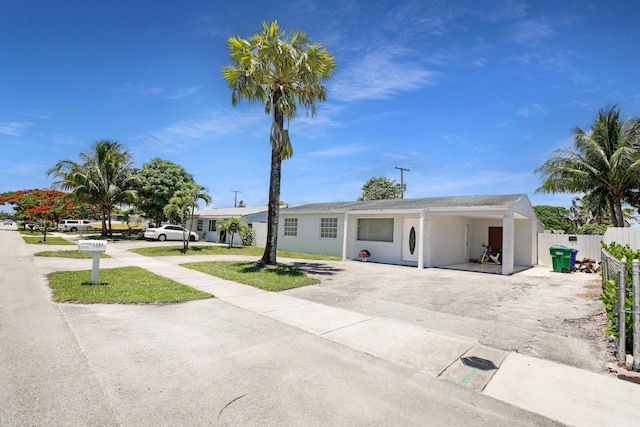 1395 SW 46 Th Ave, Fort Lauderdale, FL 33317 - ranch-style home with driveway, an attached carport, and stucco siding