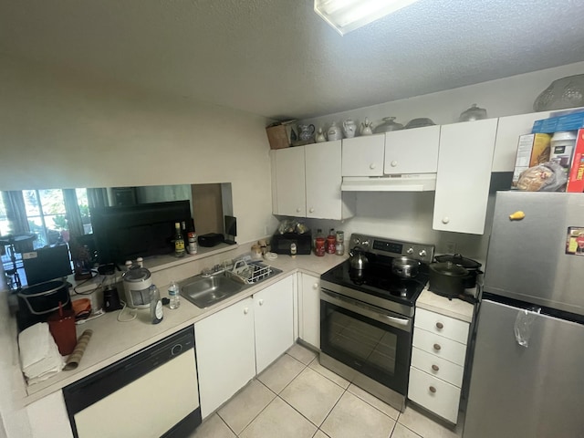 2401 NW 56th Ave Unit 3-103, Lauderhill, FL 33313 - kitchen featuring appliances with stainless steel finishes, under cabinet range hood, light countertops, white cabinets, and light tile patterned flooring