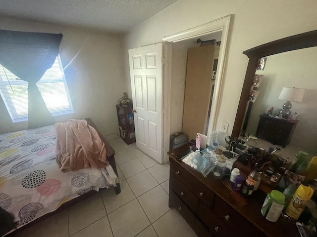 2401 NW 56th Ave Unit 3-103, Lauderhill, FL 33313 - bedroom with light tile patterned flooring and a textured ceiling