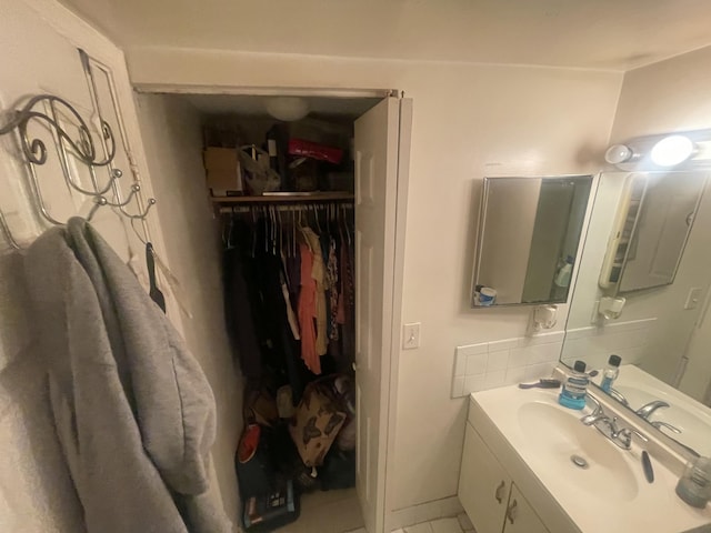 2401 NW 56th Ave Unit 3-103, Lauderhill, FL 33313 - bathroom featuring vanity, tile patterned floors, and a spacious closet