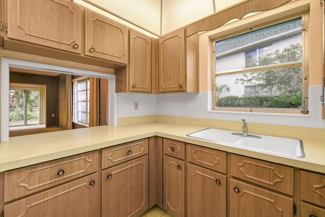 1900 S Kanner Hwy Unit 3-108, Stuart, FL 34994 - kitchen featuring light countertops and brown cabinetry