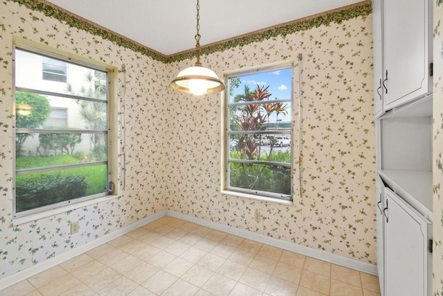 1900 S Kanner Hwy Unit 3-108, Stuart, FL 34994 - unfurnished dining area featuring wallpapered walls, plenty of natural light, and crown molding