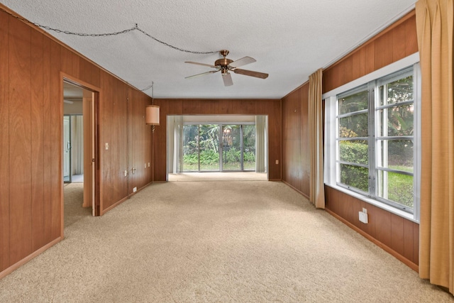 1900 S Kanner Hwy Unit 3-108, Stuart, FL 34994 - carpeted spare room with healthy amount of natural light, wooden walls, a ceiling fan, and a textured ceiling