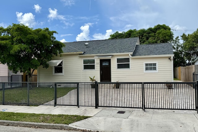 942 Sunset Rd, West Palm Beach, FL 33401 - view of front of home featuring a fenced front yard and roof with shingles